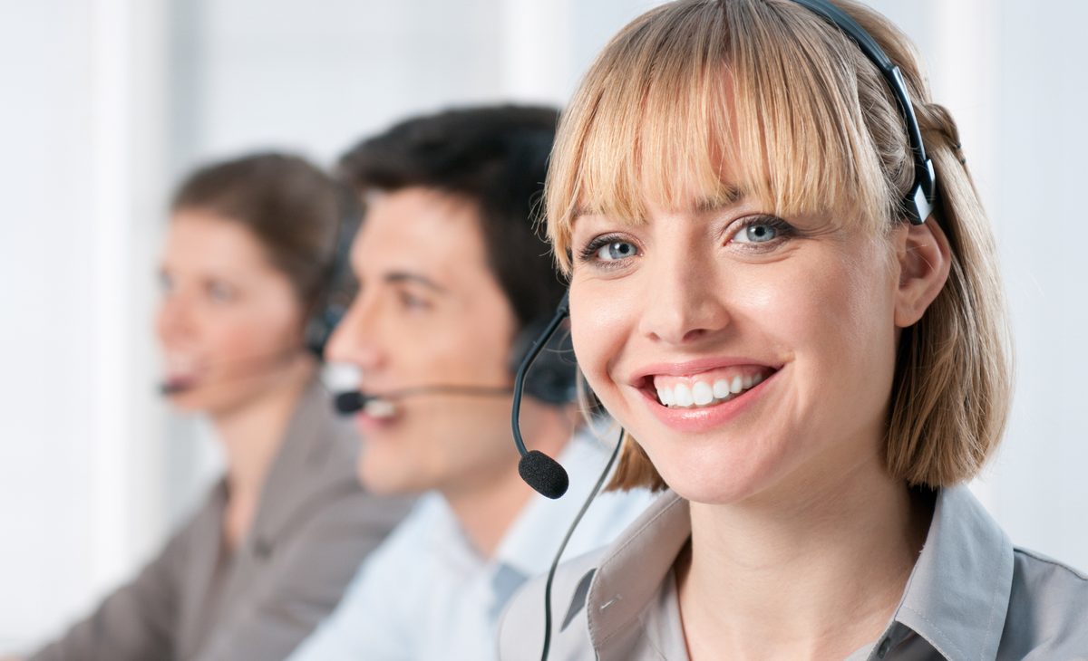 Smiling team member on a call using a headset